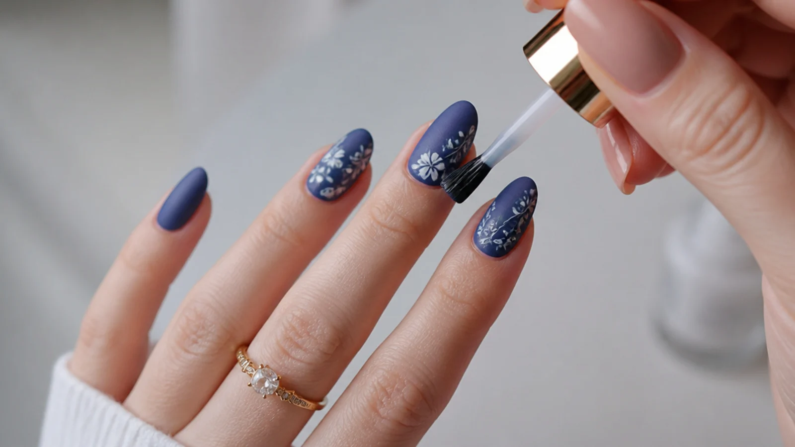 A matte top coat brushed over cured blue gel on a nail at home