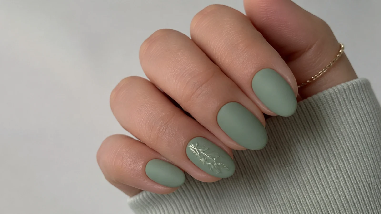 Soft muted sage green matte nails on short almond nails