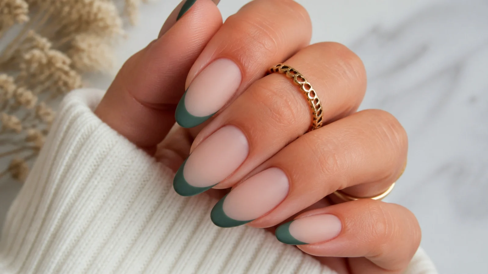 Matte pine green French tip nails over a nude base on almond nails