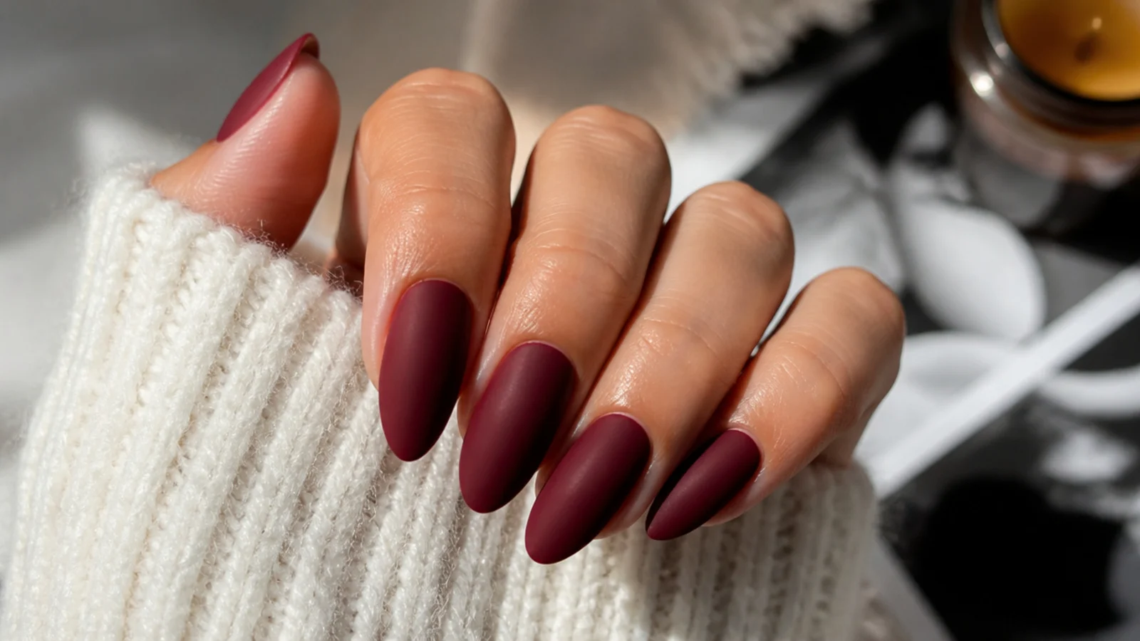 Deep matte oxblood red almond nails with a velvety finish