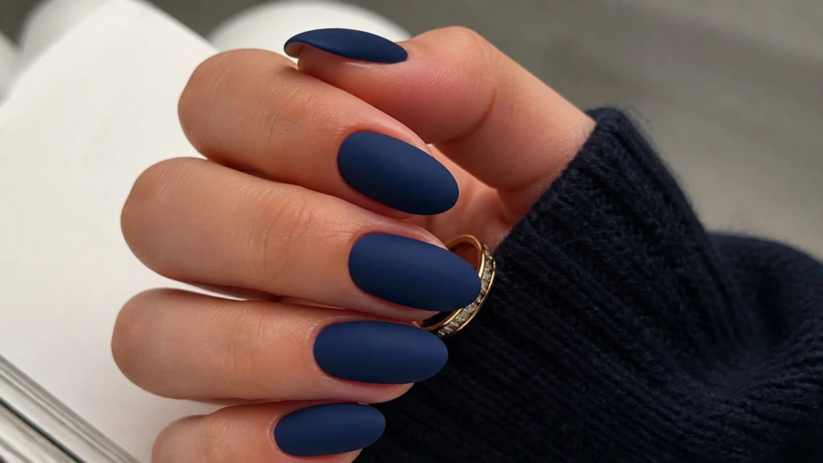 Deep matte navy blue almond nails with a velvety finish