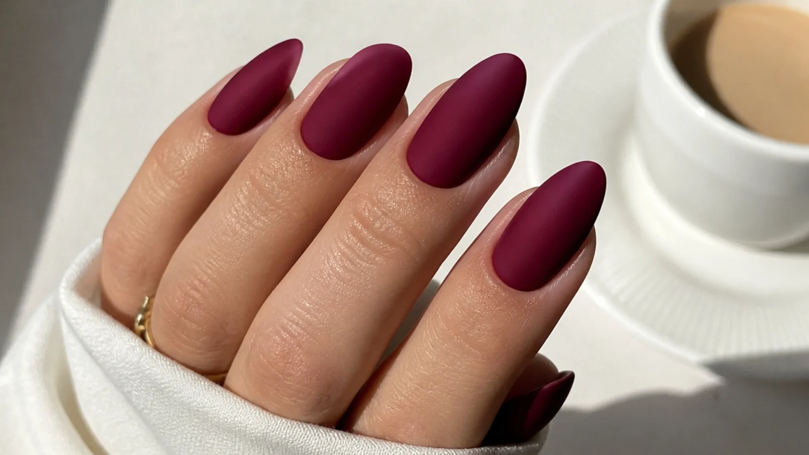 Deep matte burgundy wine almond nails with a suede finish