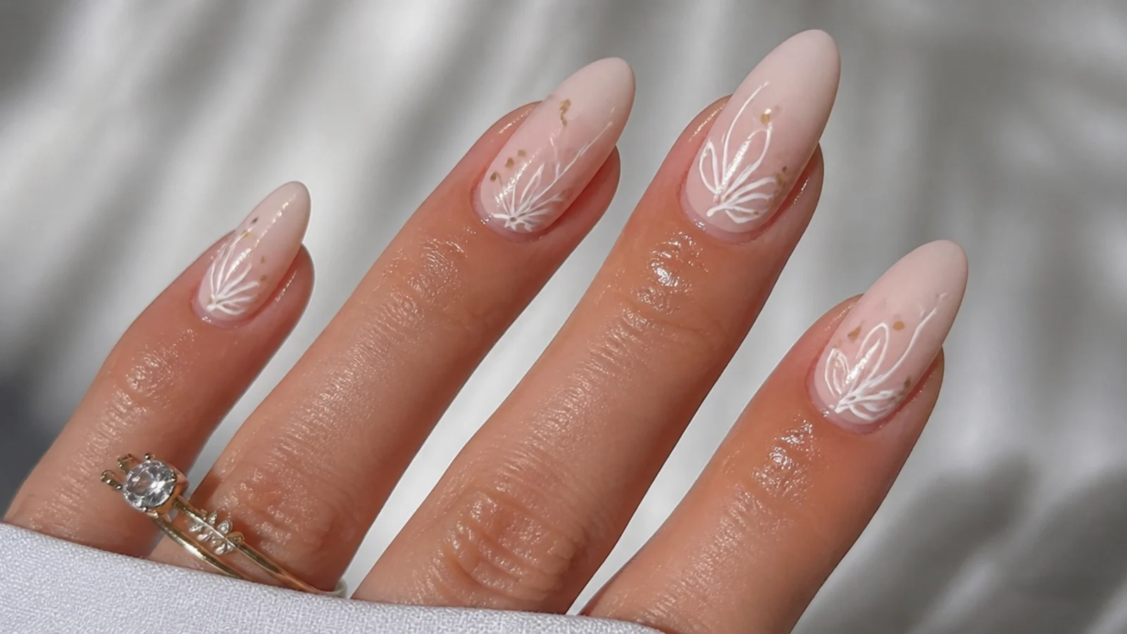 Cuticle oil applied around the nail, not across the matte surface