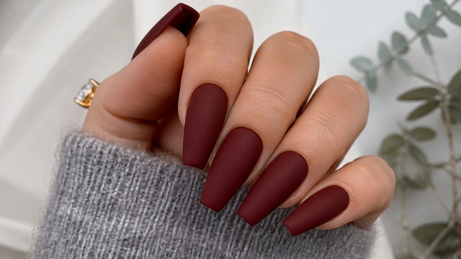 Deep matte oxblood red nails on a coffin shape