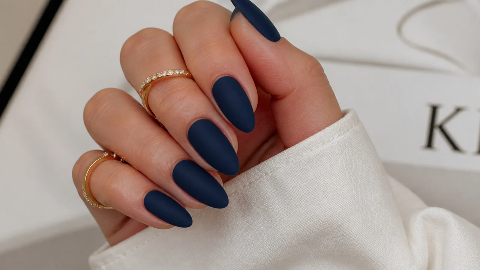 Deep matte navy blue nails on an almond shape