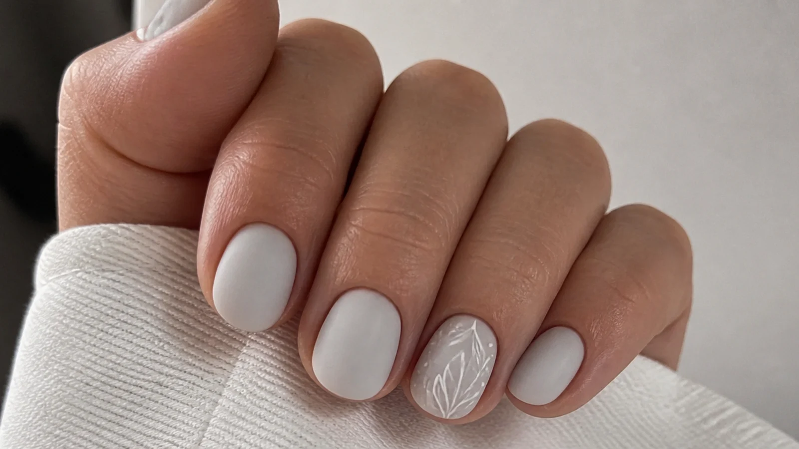 Short round nails in matte milky white with a soft chalky finish