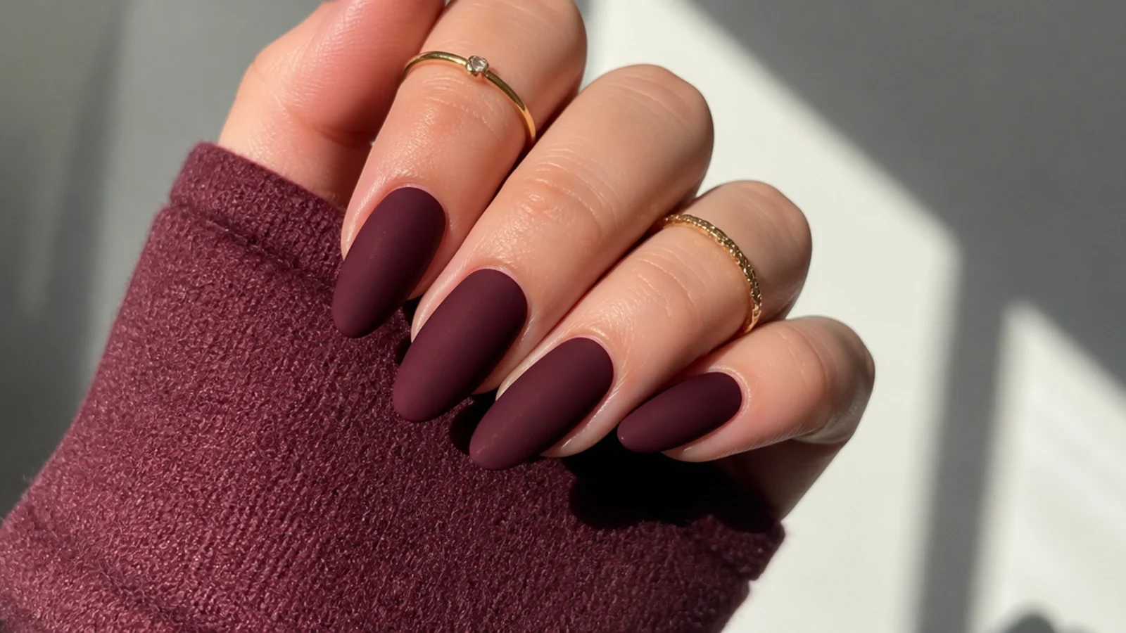 Almond nails in matte burgundy wine with a deep crushed-berry velvet finish