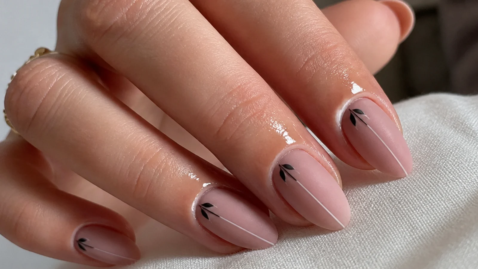 Cuticle oil applied around the edge of a matte nail, not across the plate