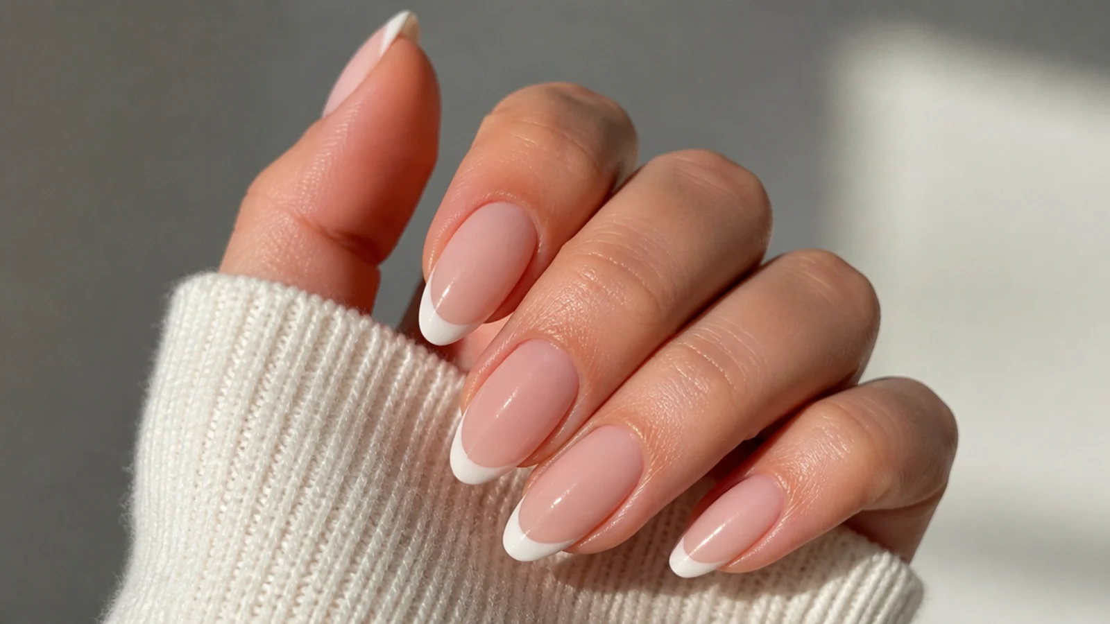 Matte nude French manicure with soft white tips on almond nails