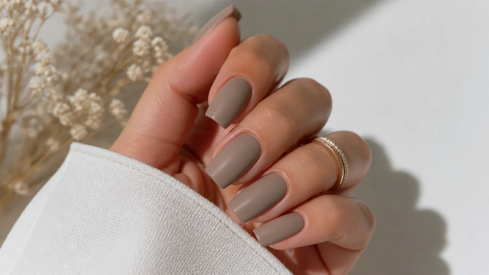 Soft matte taupe greige nails on a squoval shape