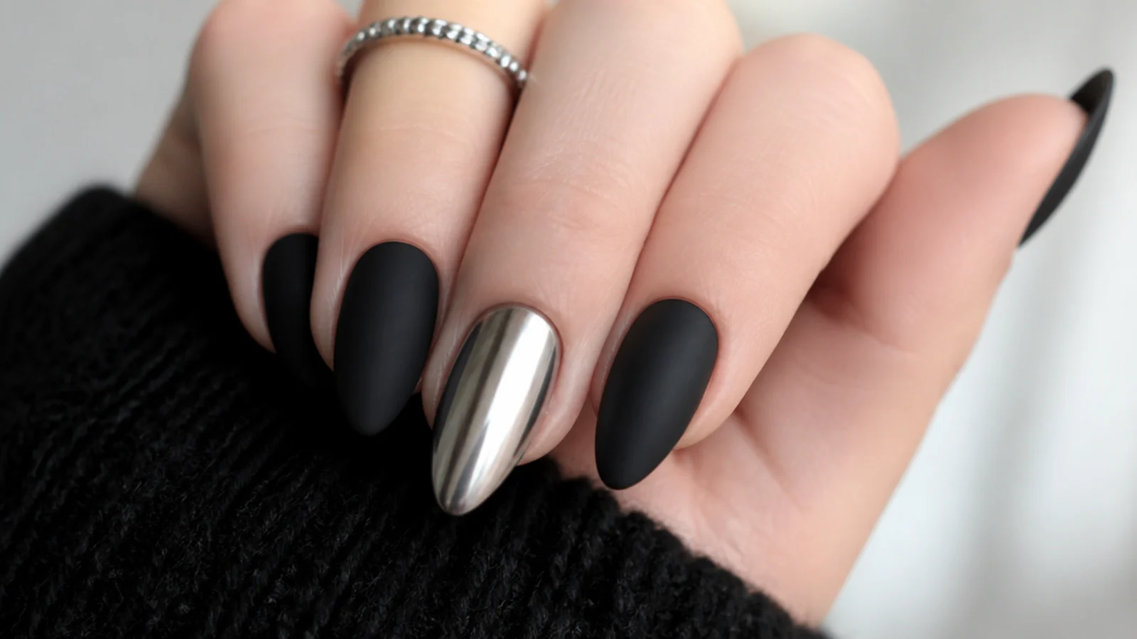 Matte black nails with one metallic chrome accent nail