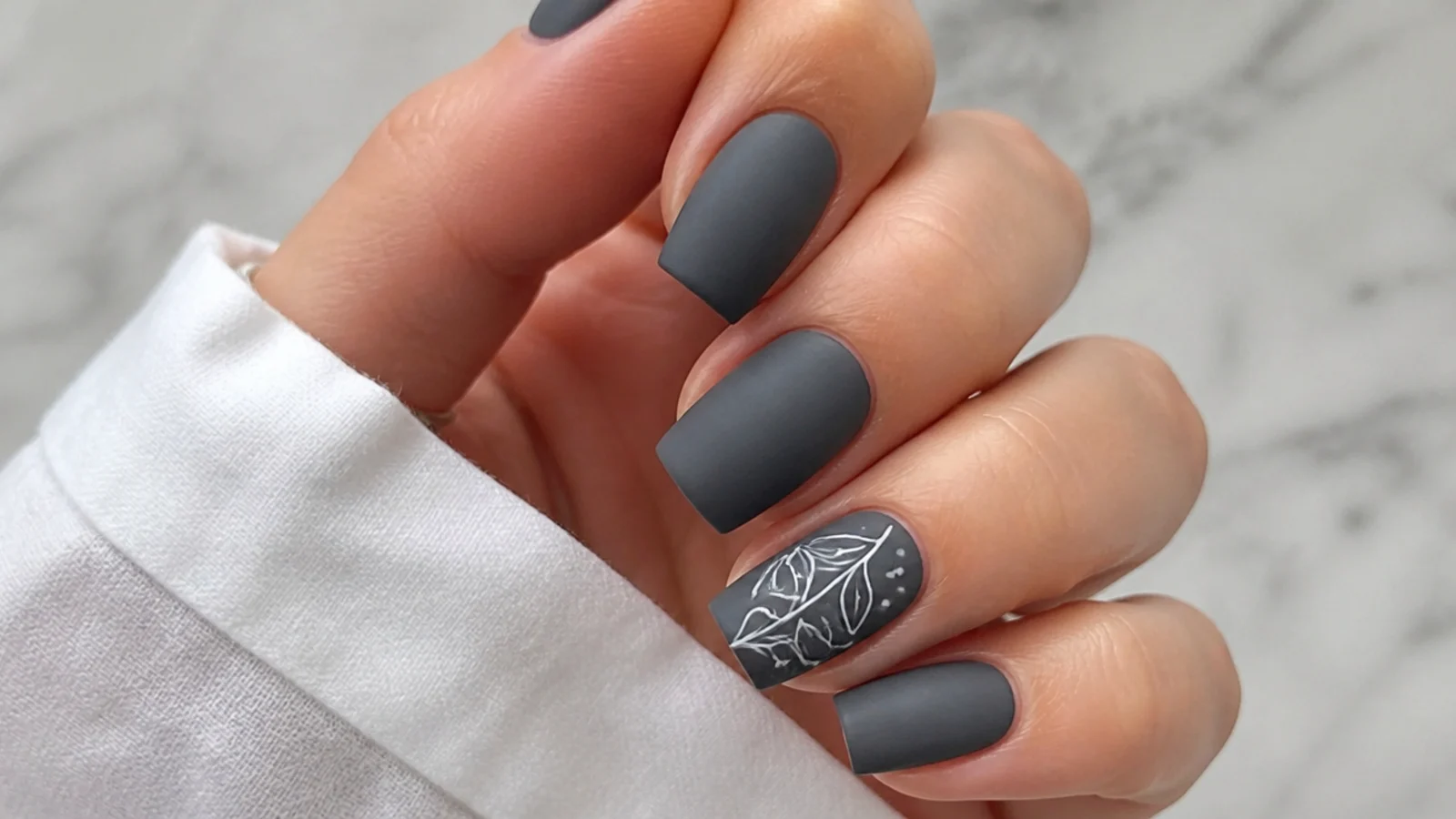 Soft matte charcoal gray nails on a square shape