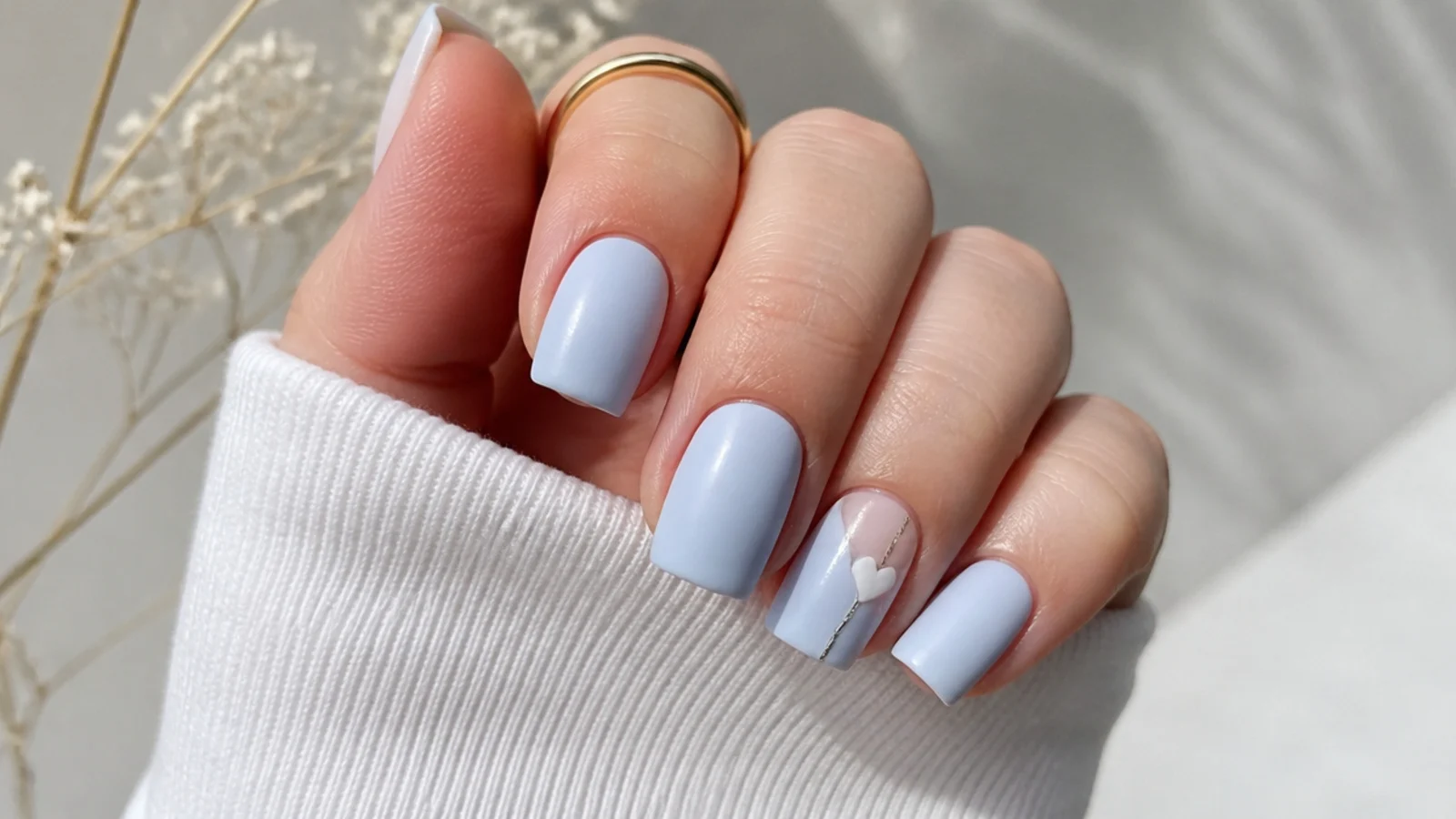 Soft matte icy pale blue nails on a short square shape