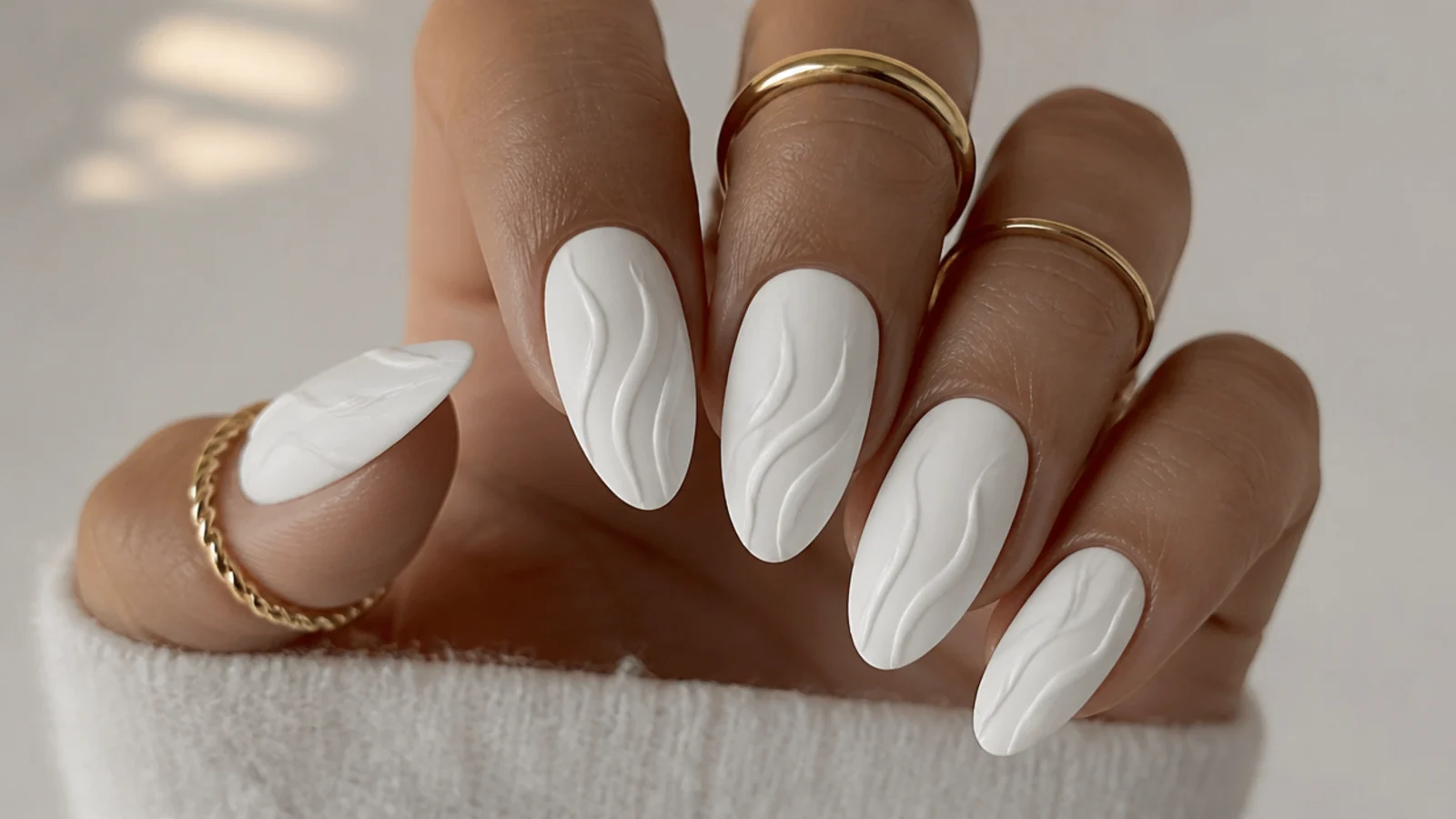 Matte white nails with a raised glossy white swirl on top