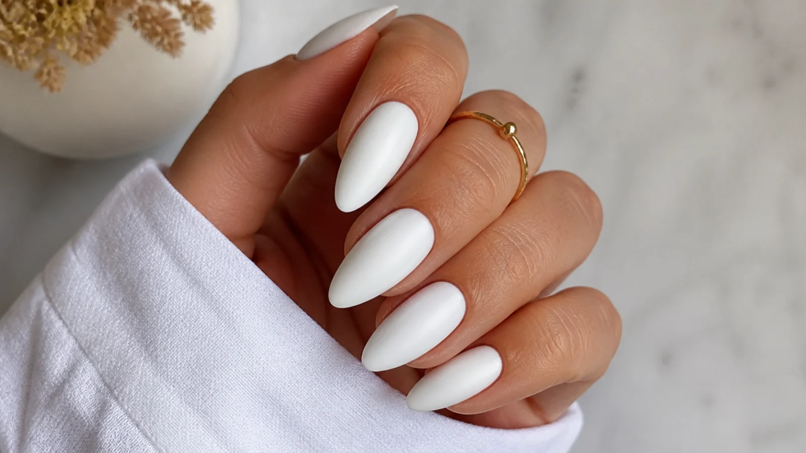 Long matte white almond nails with a clean velvety finish