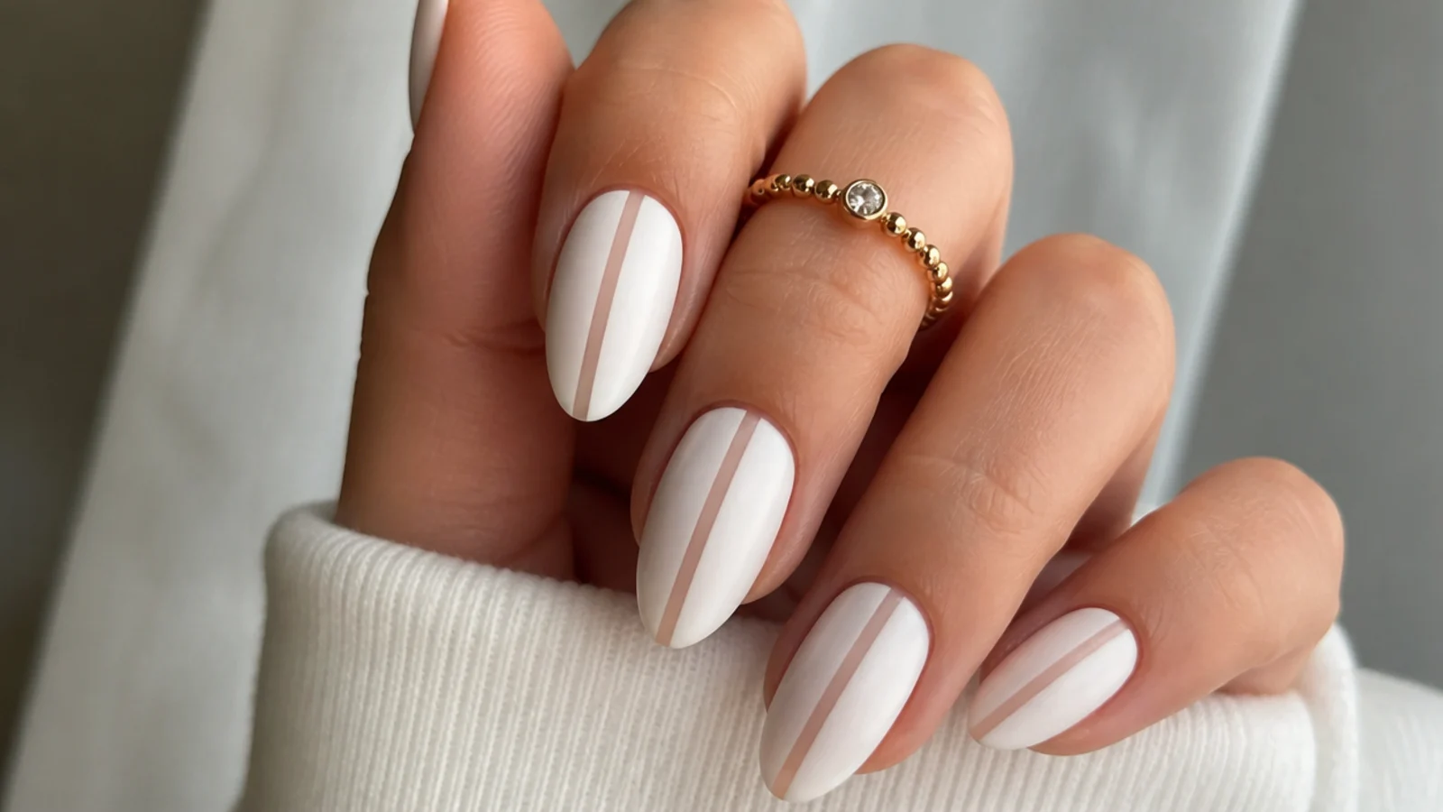 Matte white nails with a bare negative-space stripe down the center