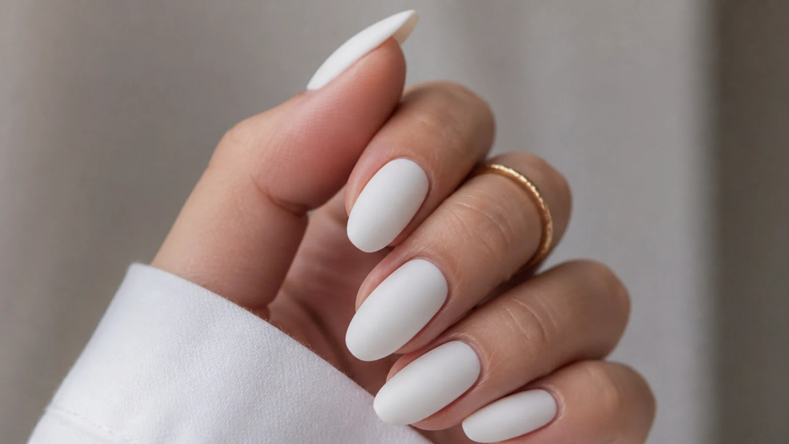 Soft matte white nails on an almond shape with a velvety non-shiny finish