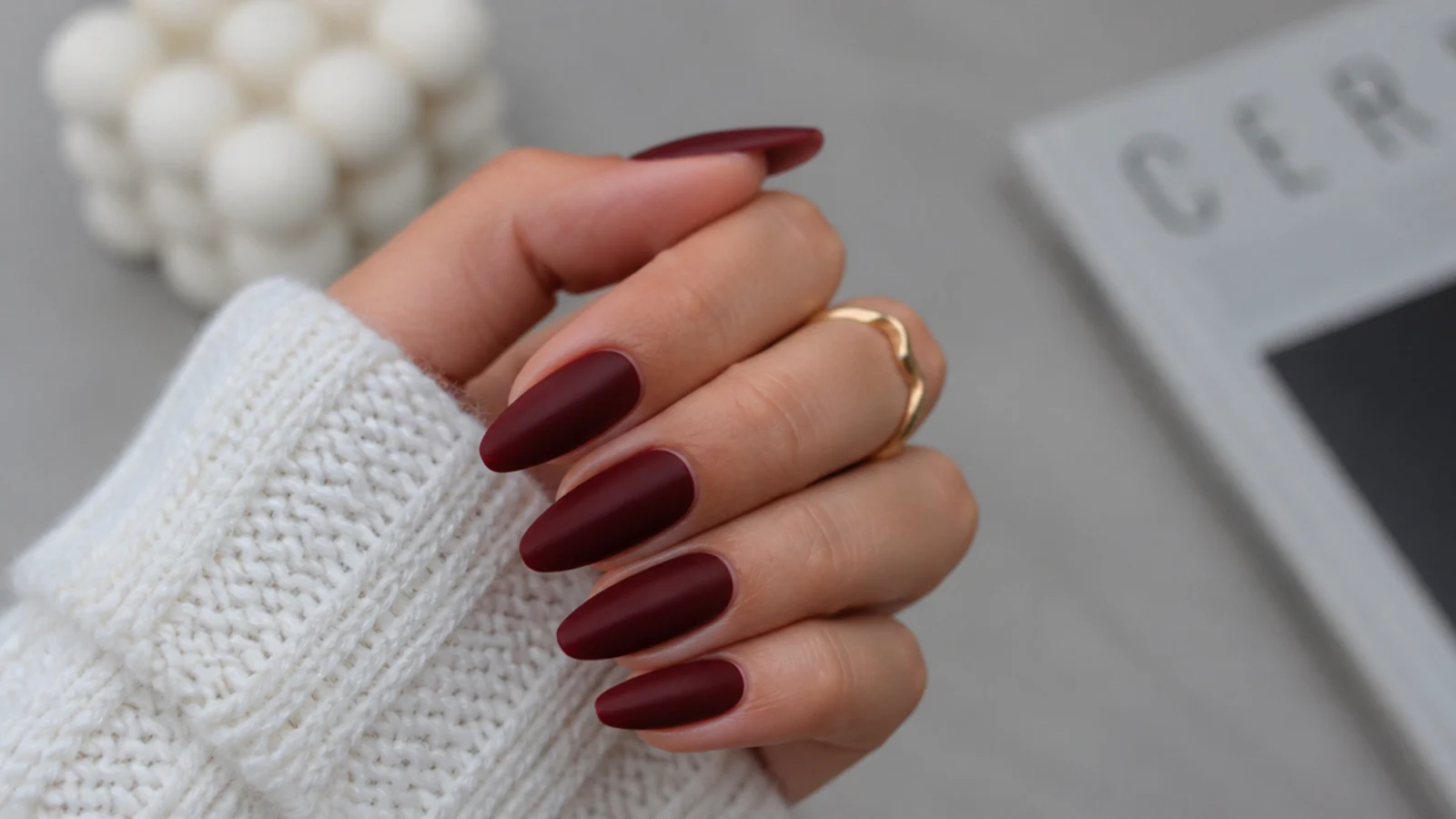 Long burgundy matte nails on a slender almond shape