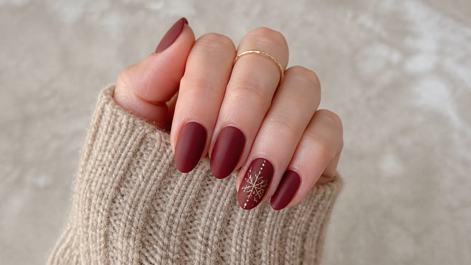 Deep maroon matte nails on a short almond shape for winter