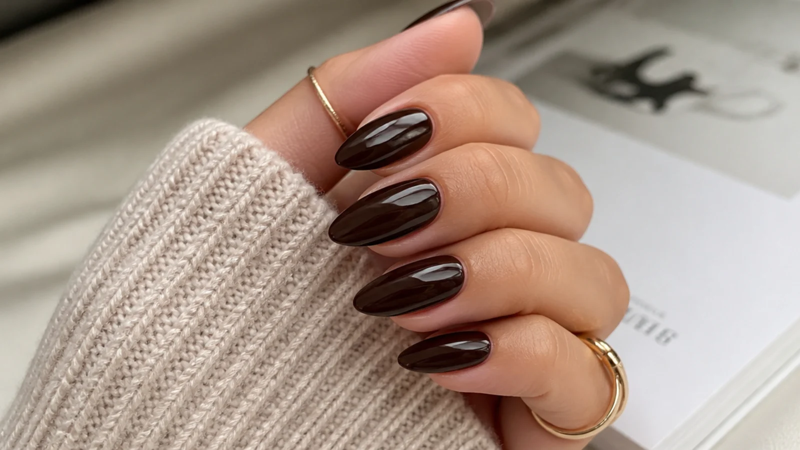 Medium almond nails in deep glossy chocolate espresso brown with a rounded point