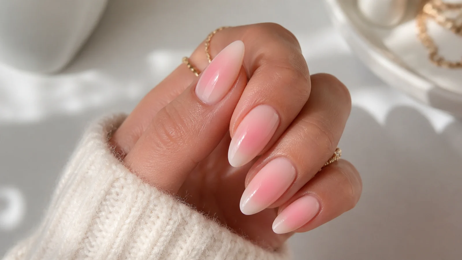 Medium almond nails with a soft pink aura halo airbrushed into the center of a nude base