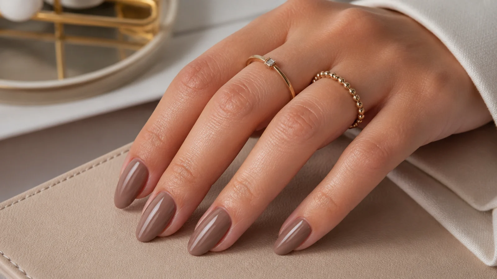 Medium almond nails in soft milky mocha mousse brown with a creamy finish