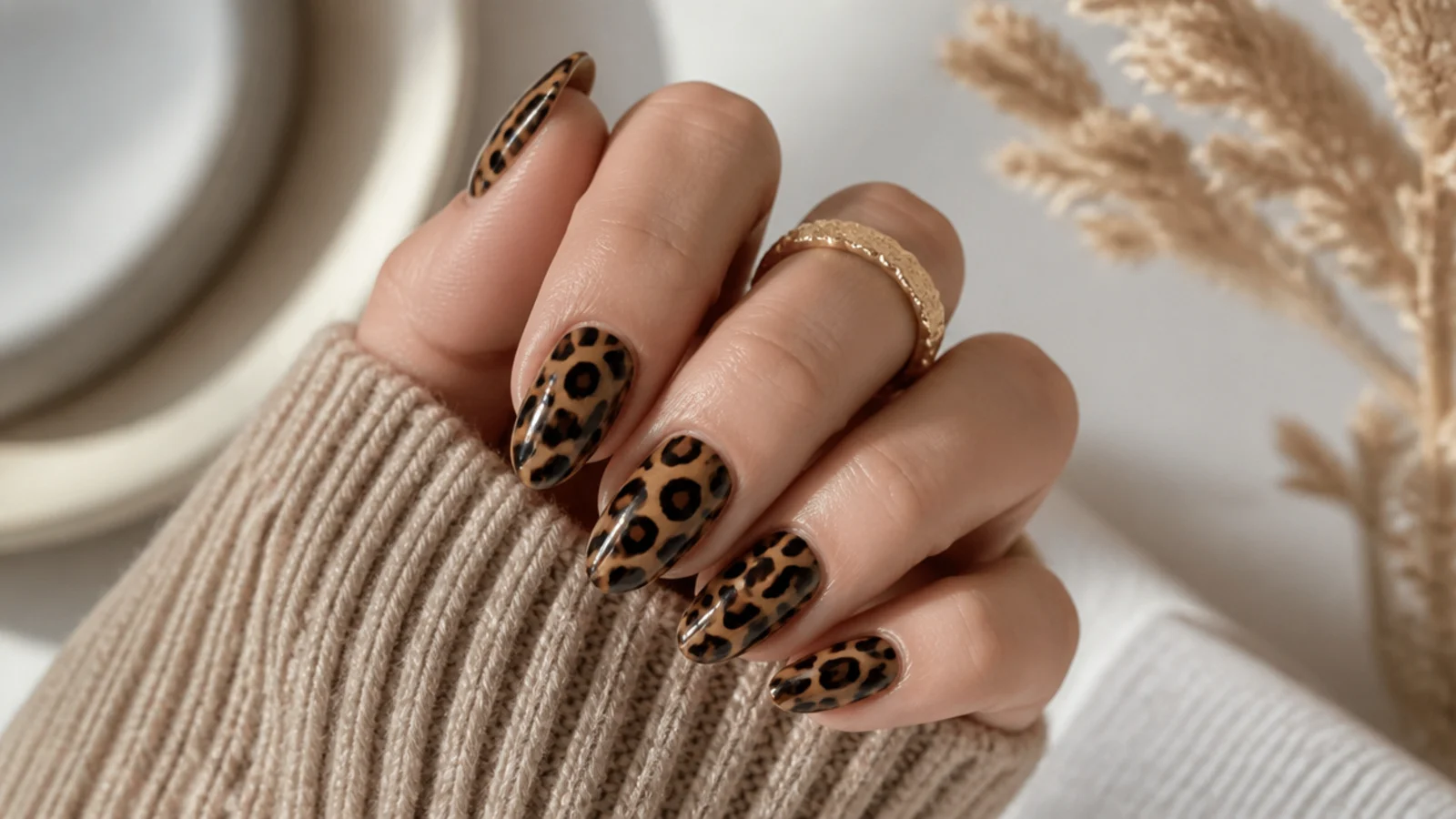 Medium almond nails with brown and black leopard print spots on a caramel base