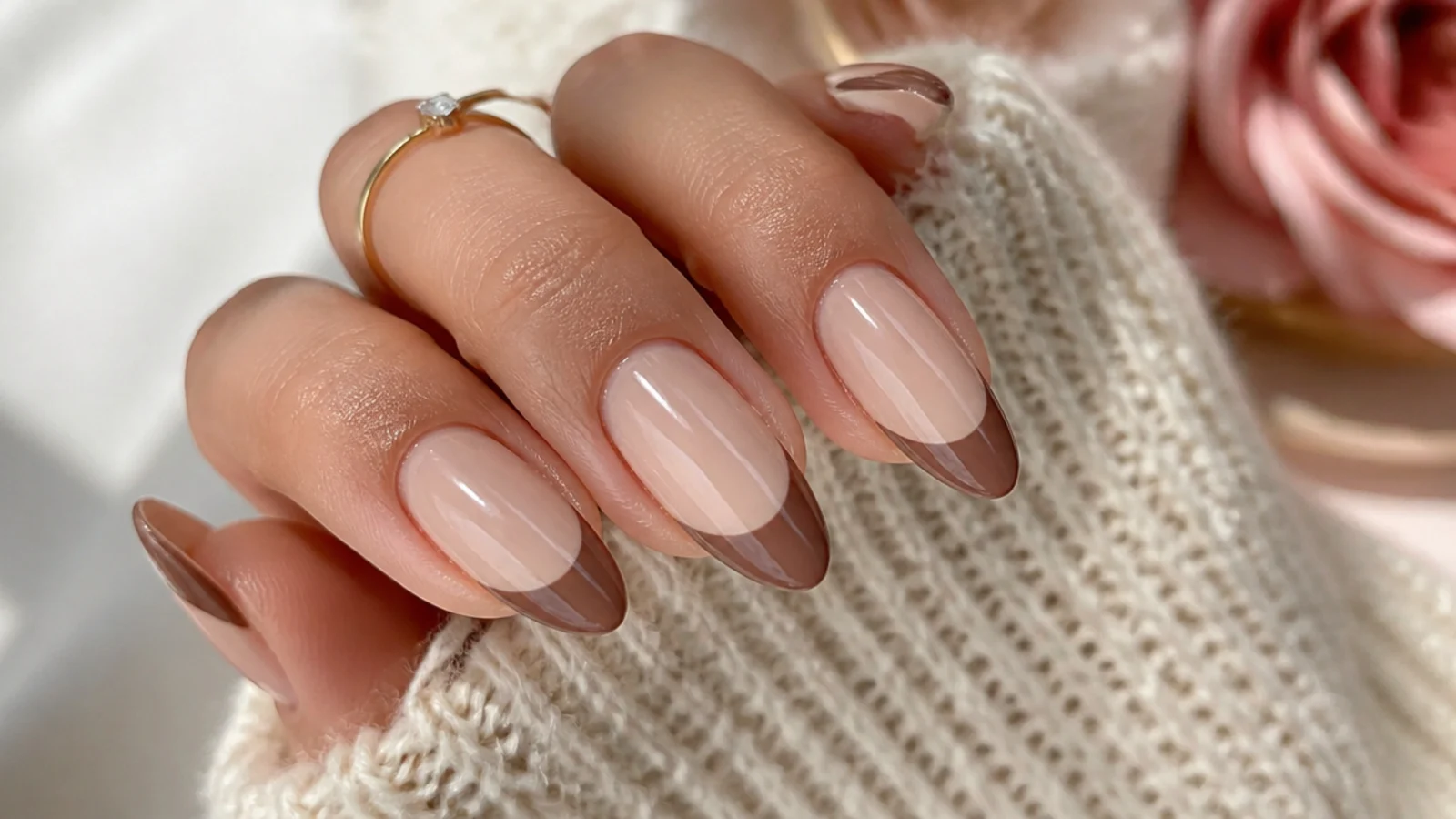 Medium almond nails with mocha brown French tips over a warm beige base for fall