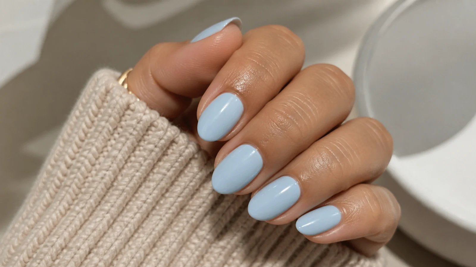 Short almond nails in soft baby blue cream with a clean glossy tip