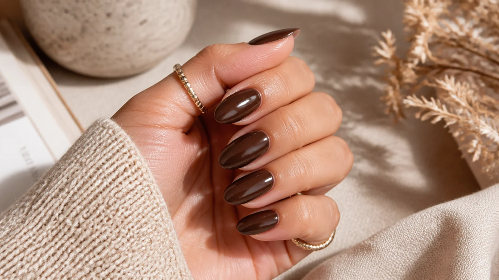 Medium almond nails in glossy chocolate brown with a rich creamy finish for fall