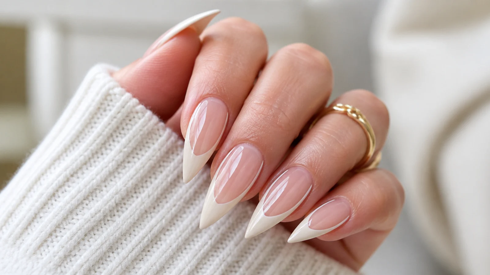 Stiletto nails with a bare central stripe framed by thin white lines and a painted point