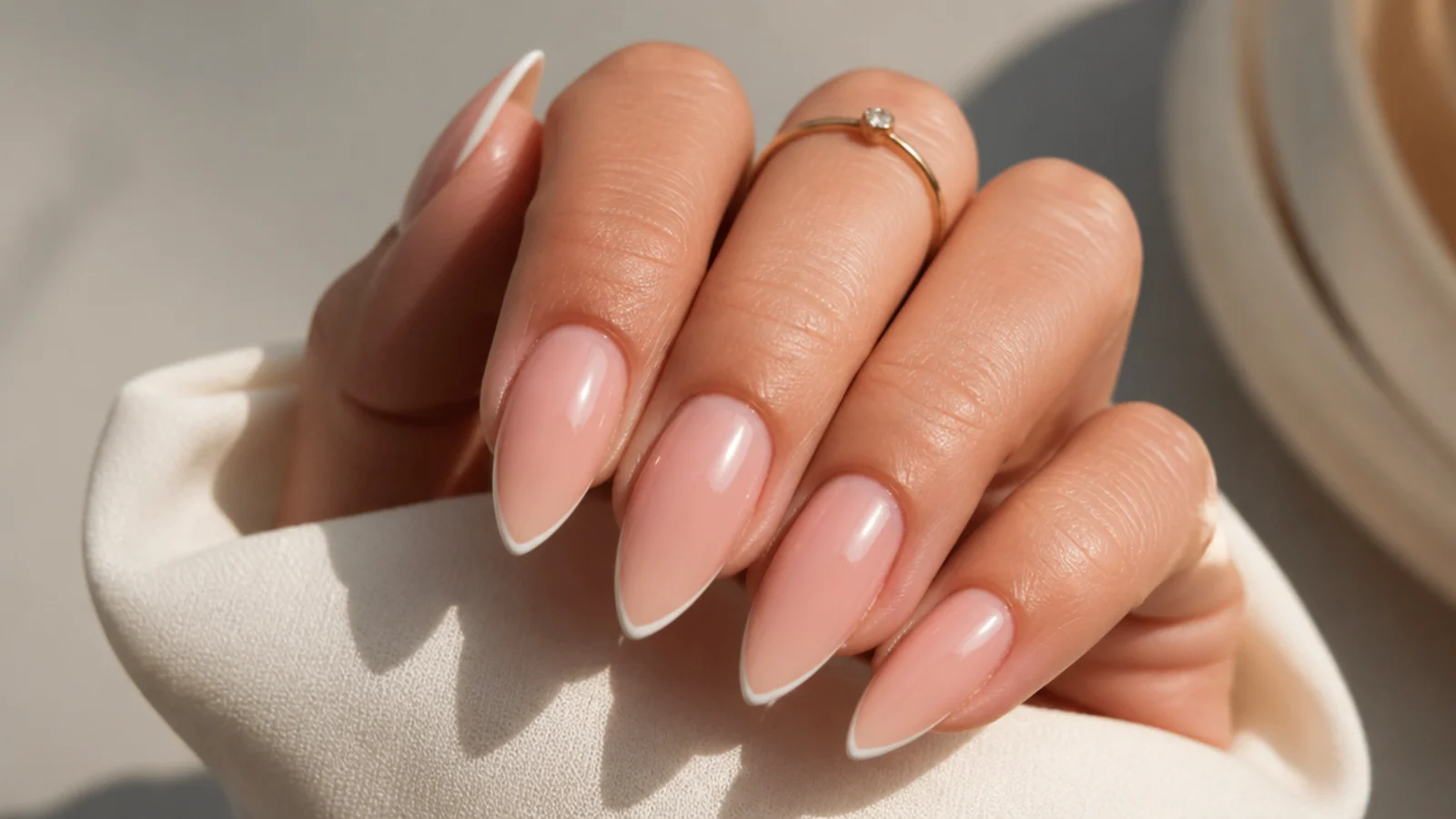 Stiletto nails with a hairline white micro French line tracing the pointed tip