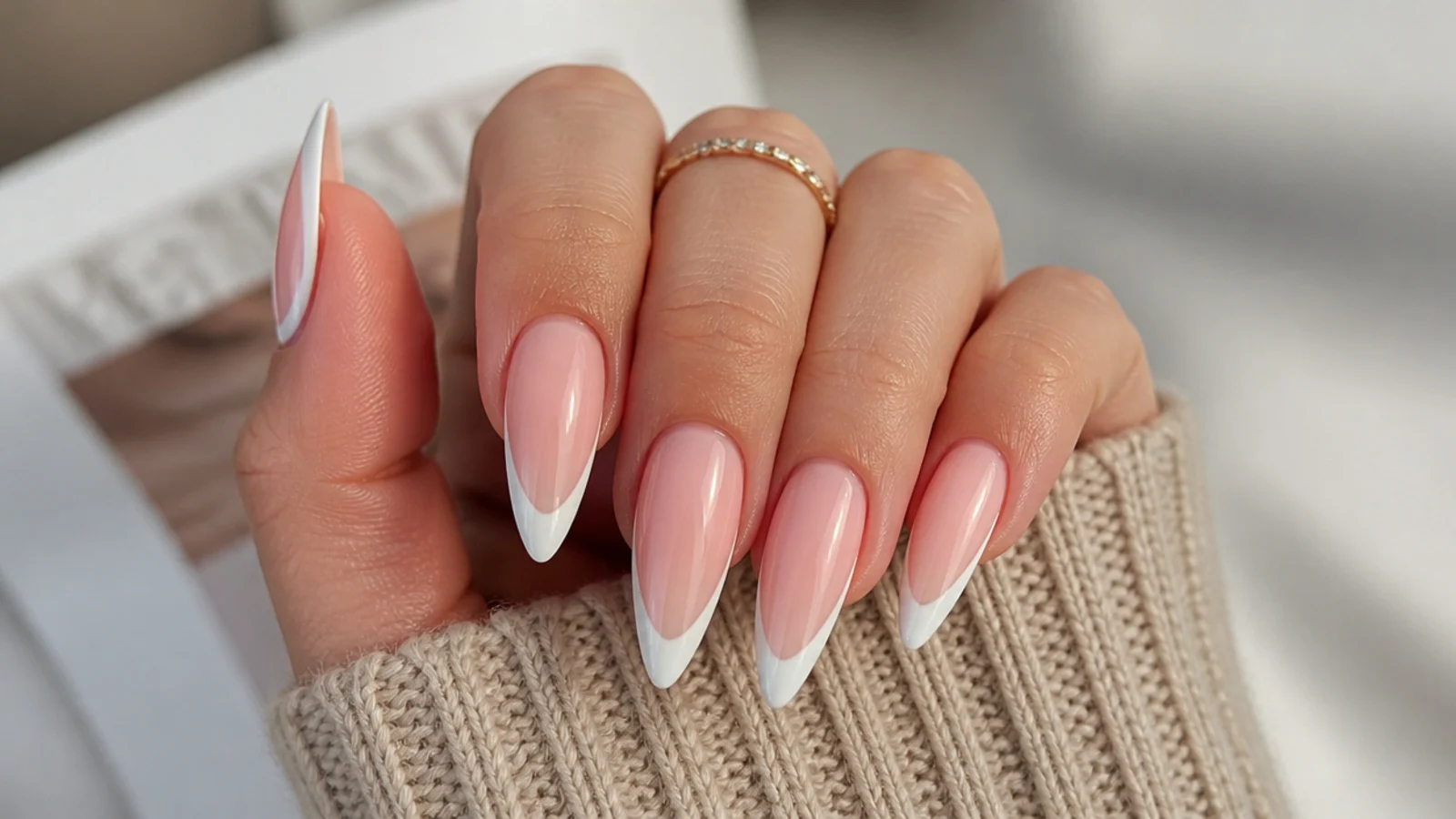 Long stiletto nails with a crisp white French tip following the pointed edge