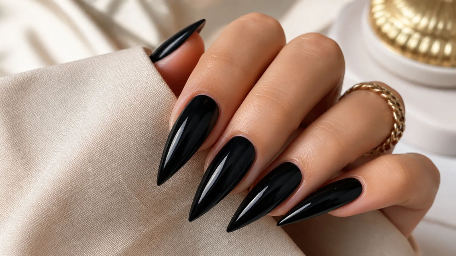 Long glossy black stiletto nails with a high-shine mirror-like point