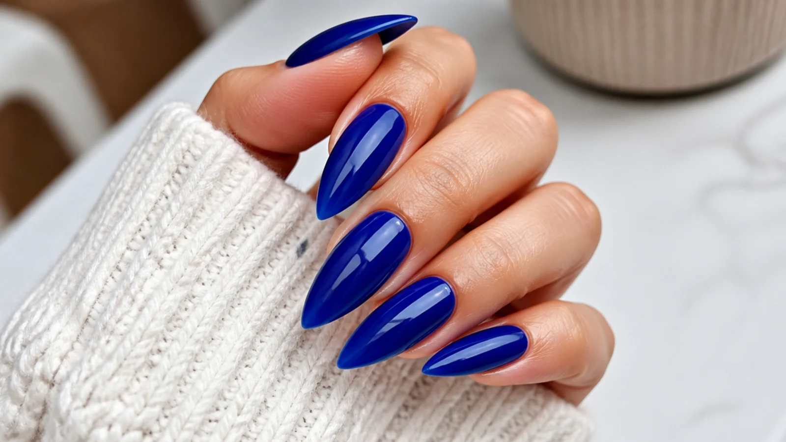 Long royal blue stiletto nails in a vivid glossy sapphire finish