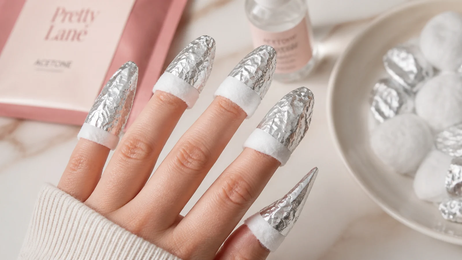 Long stiletto nails wrapped in foil and cotton soaked in acetone for at-home removal
