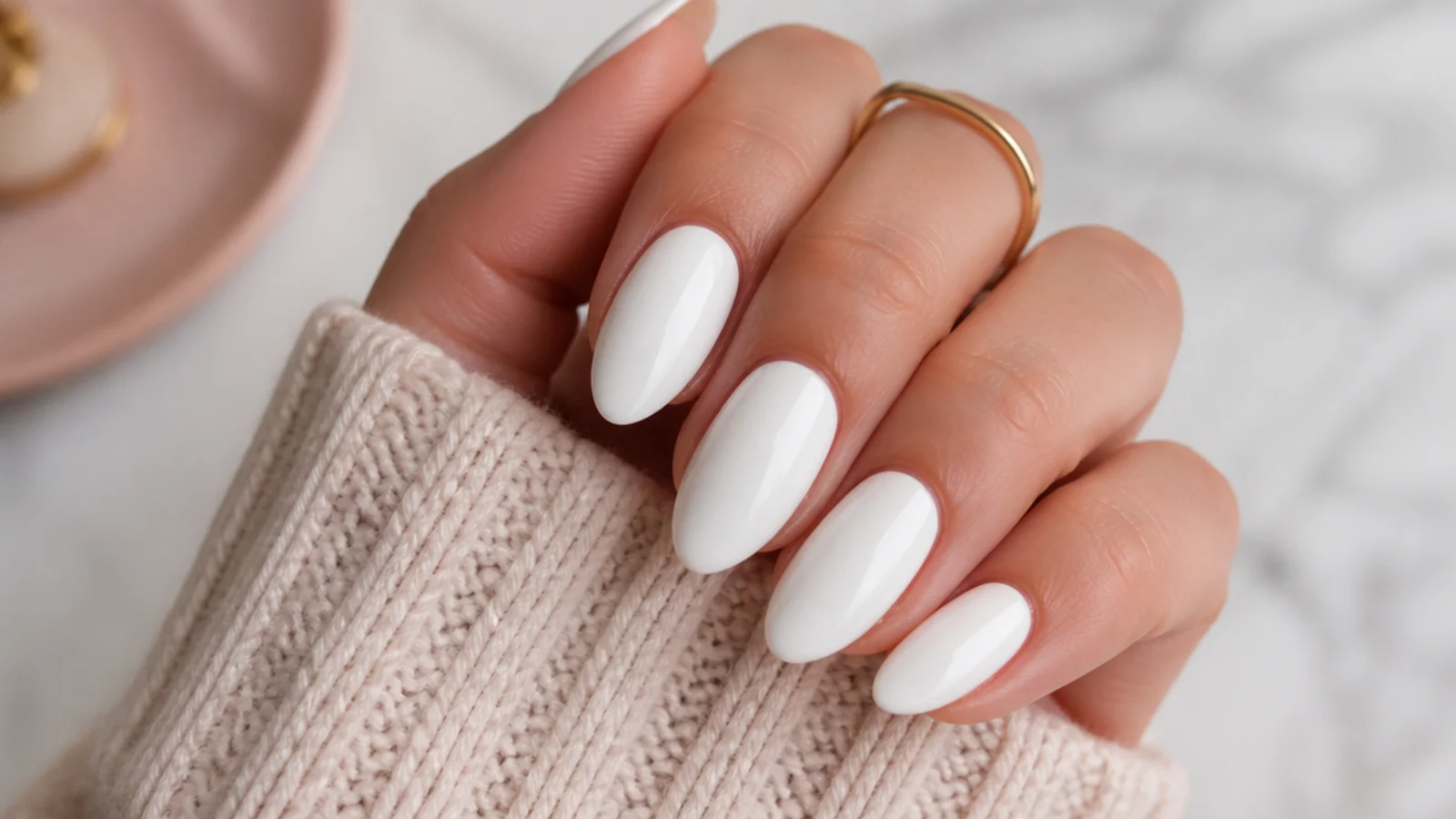 Opaque glossy bright white nails on medium almond nails with a high-shine top coat