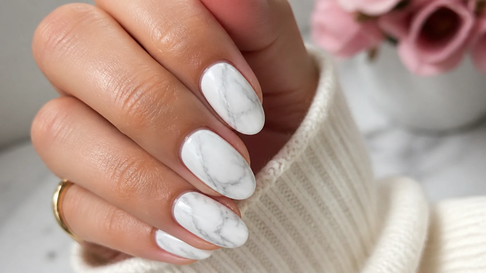 White marble nails with fine gray veining swirled across a milky white base