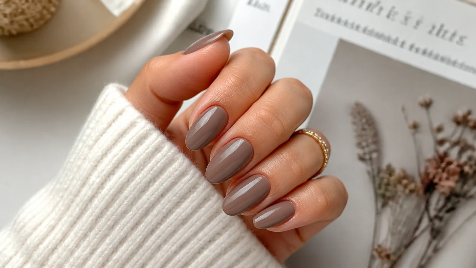 Medium taupe acrylic nails in an almond shape with a muted brown gray opaque finish