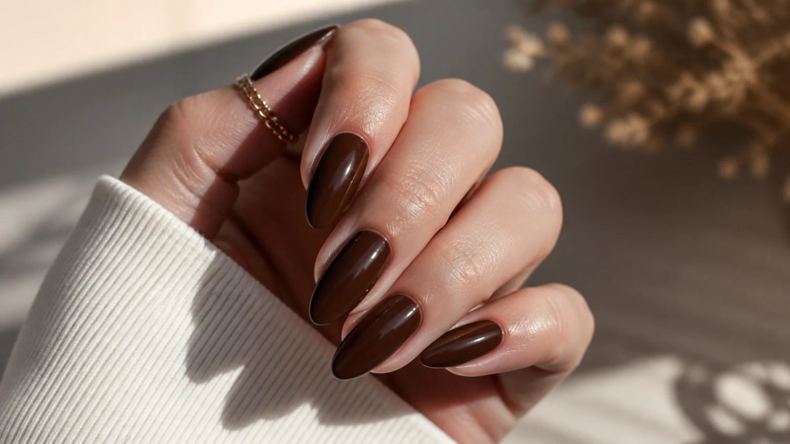 Rich mocha brown almond nails in a deep glossy chocolate shade with tapered sidewalls