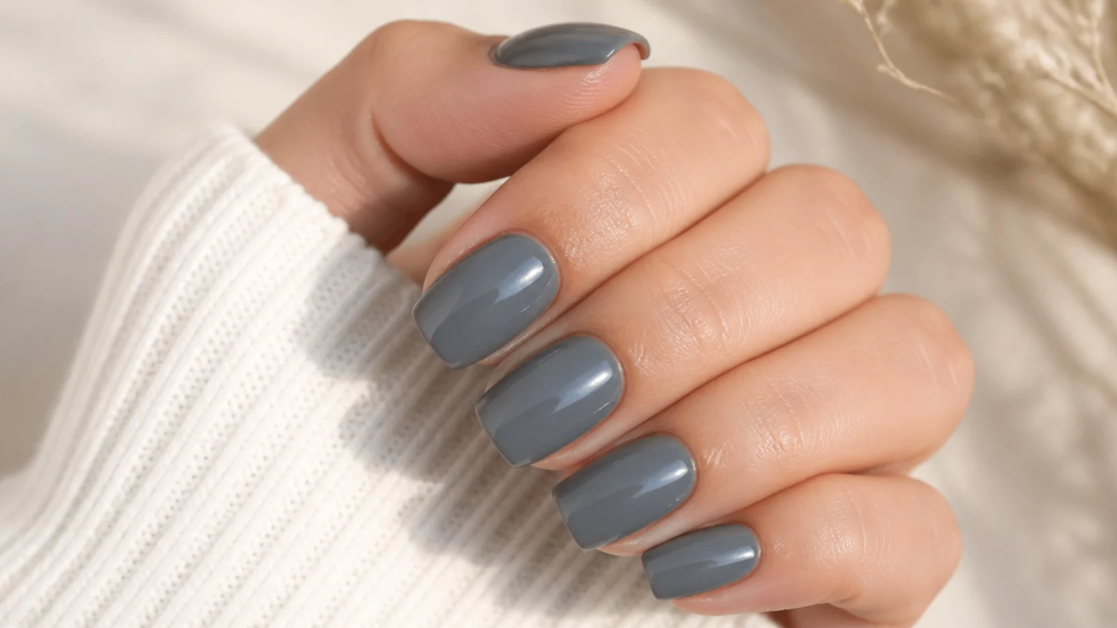 Medium length squoval nails in a muted slate gray with a clean glossy finish