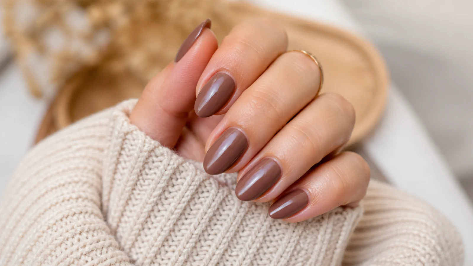 Medium almond nails in creamy mocha brown with a glossy finish
