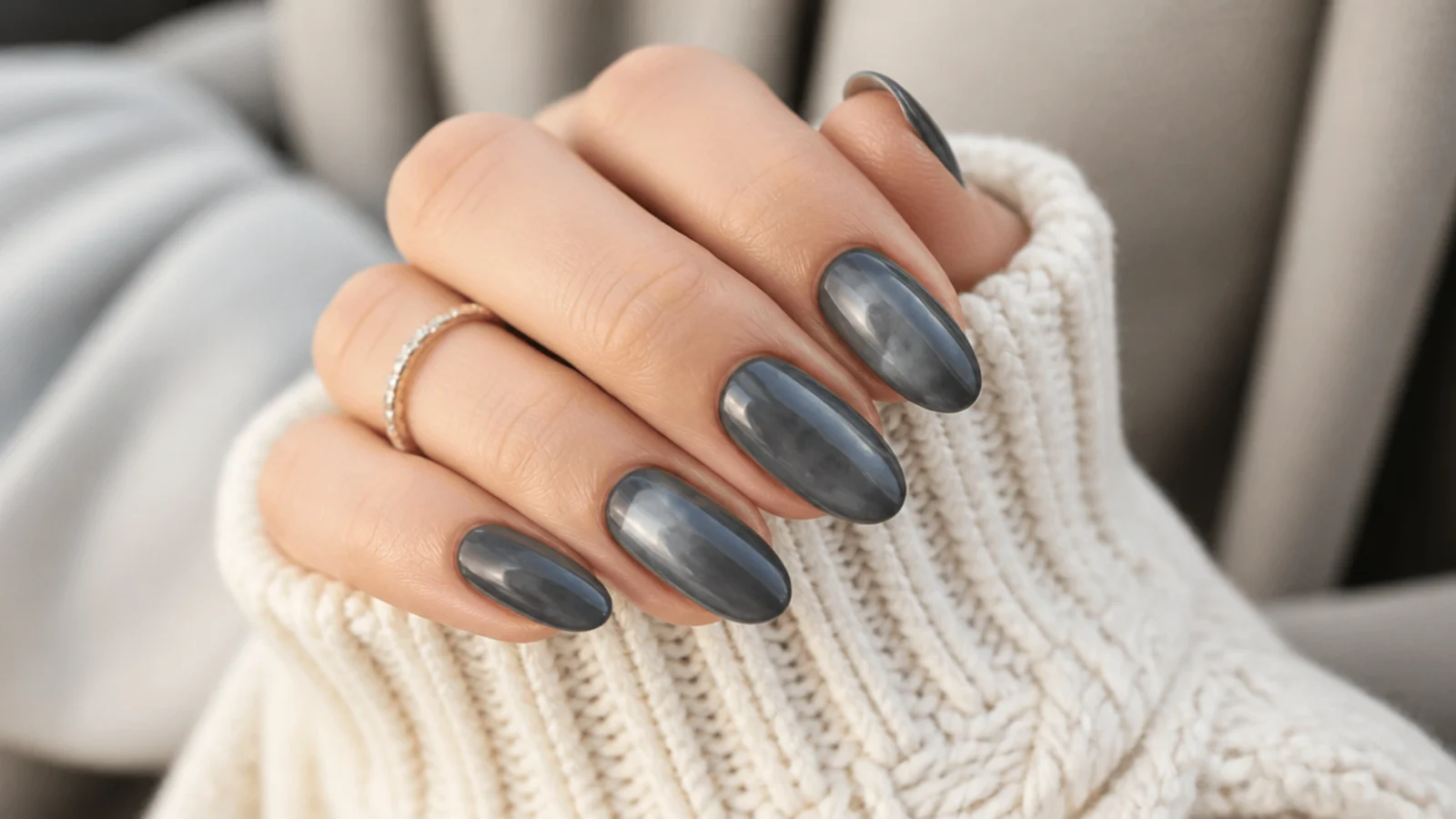 Medium almond nails in deep slate gray with a glossy stone-like finish