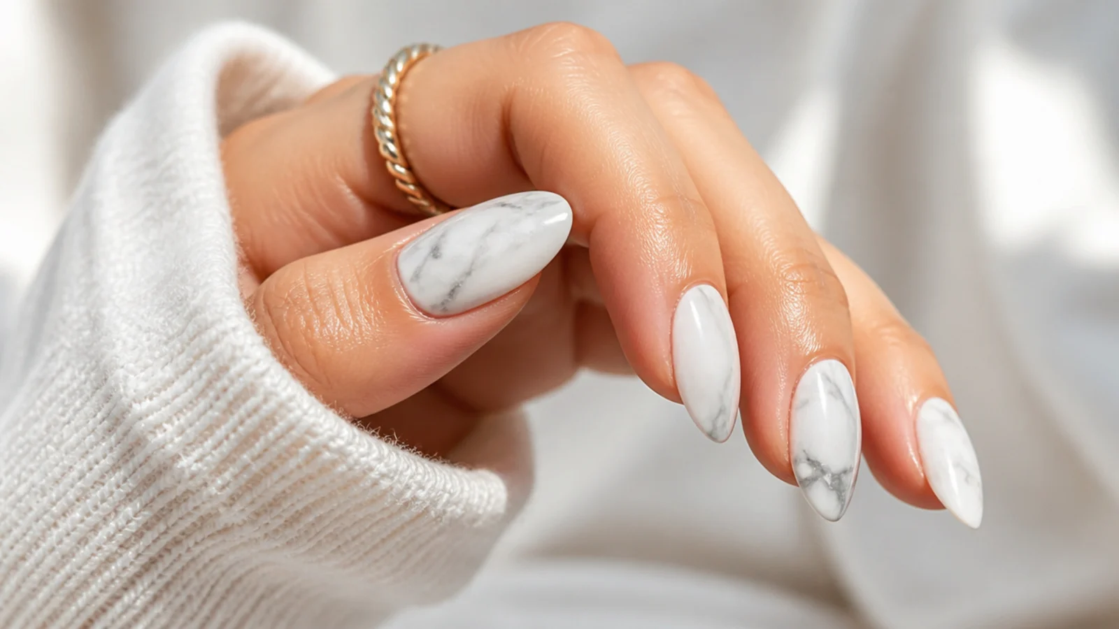 Almond nails with soft gray marble veining over a milky white base