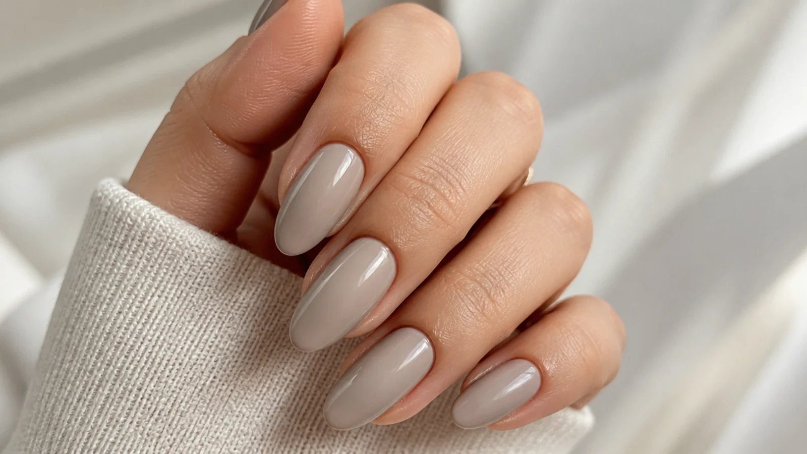 Almond greige nude nails in a gray leaning beige with a soft satin gloss