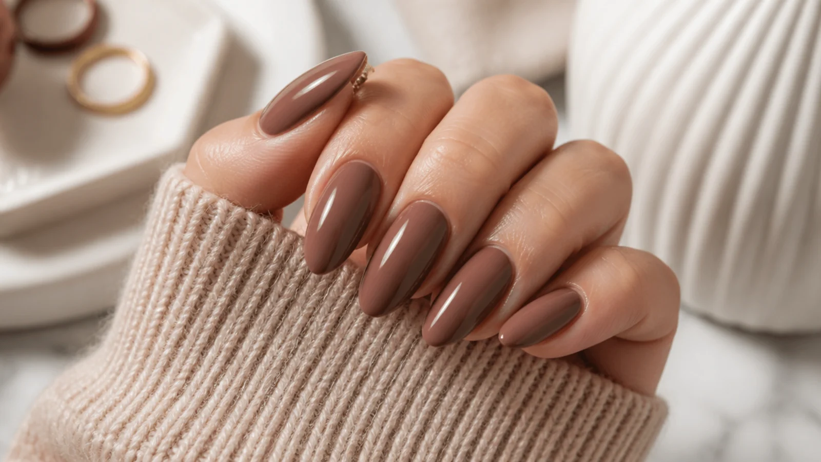 Medium almond nails in a mocha brown nude with a rich glossy finish