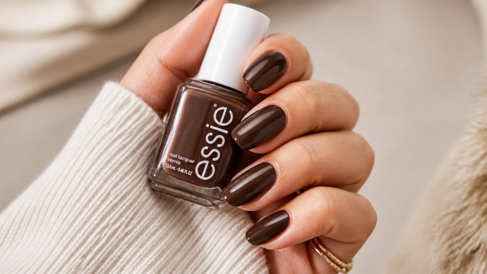 Medium almond nails in rich mocha brown Essie Mochachino with a glossy espresso finish