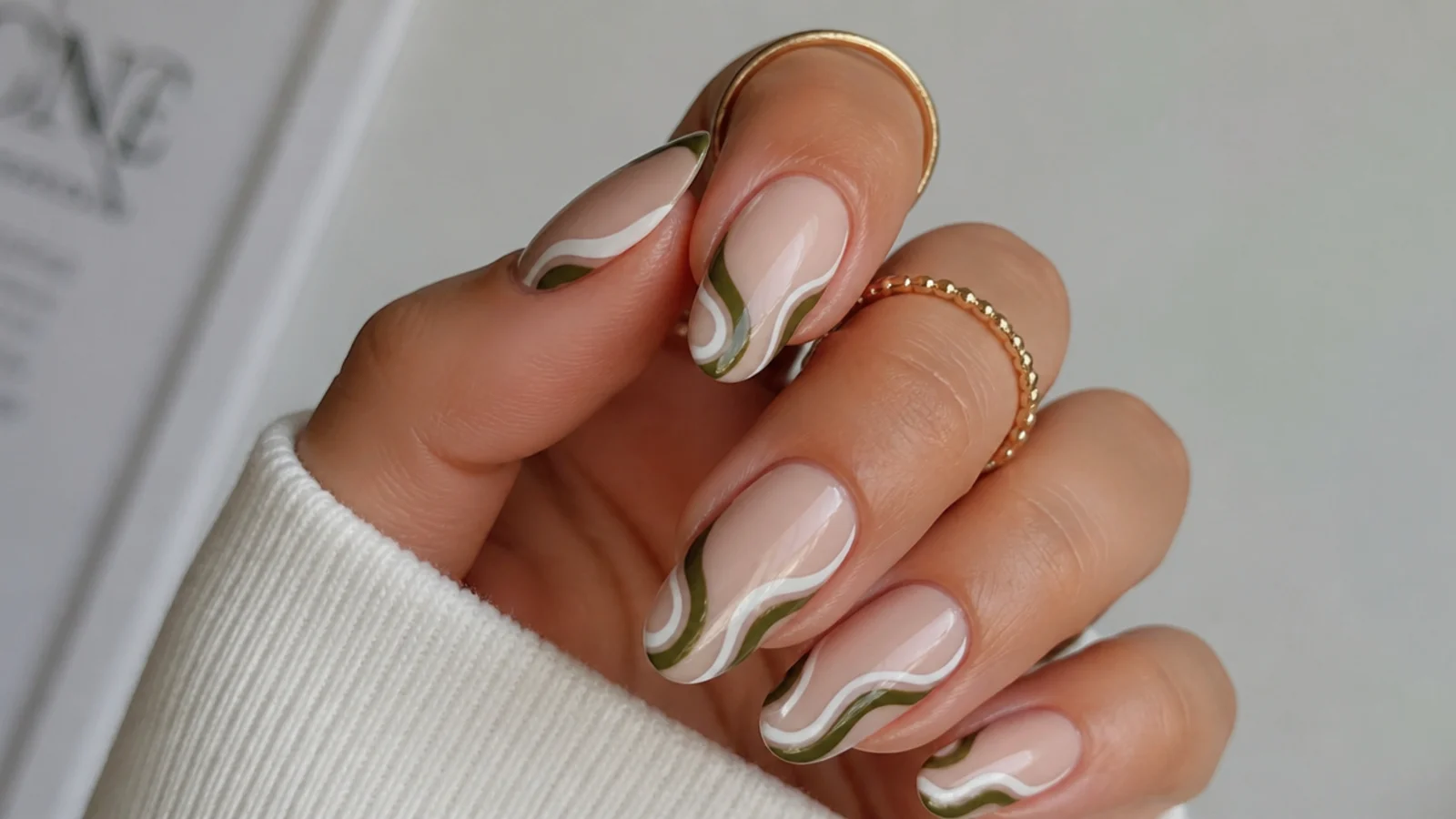 Dark olive green nails with retro white swirls on a nude base