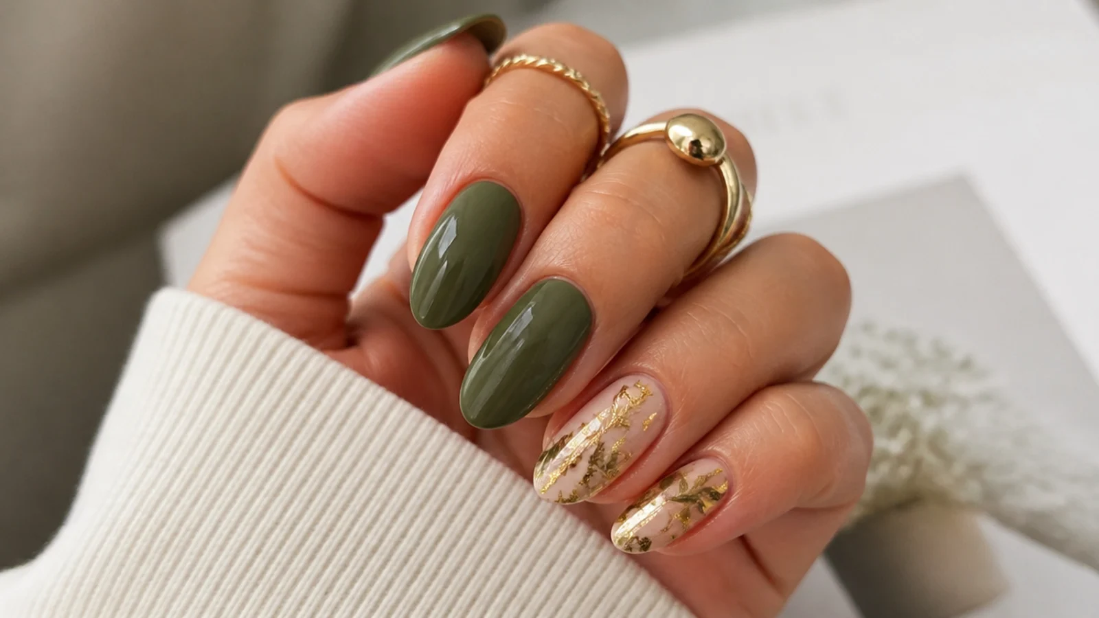 Dark olive green nails styled for a fall event with gold jewelry