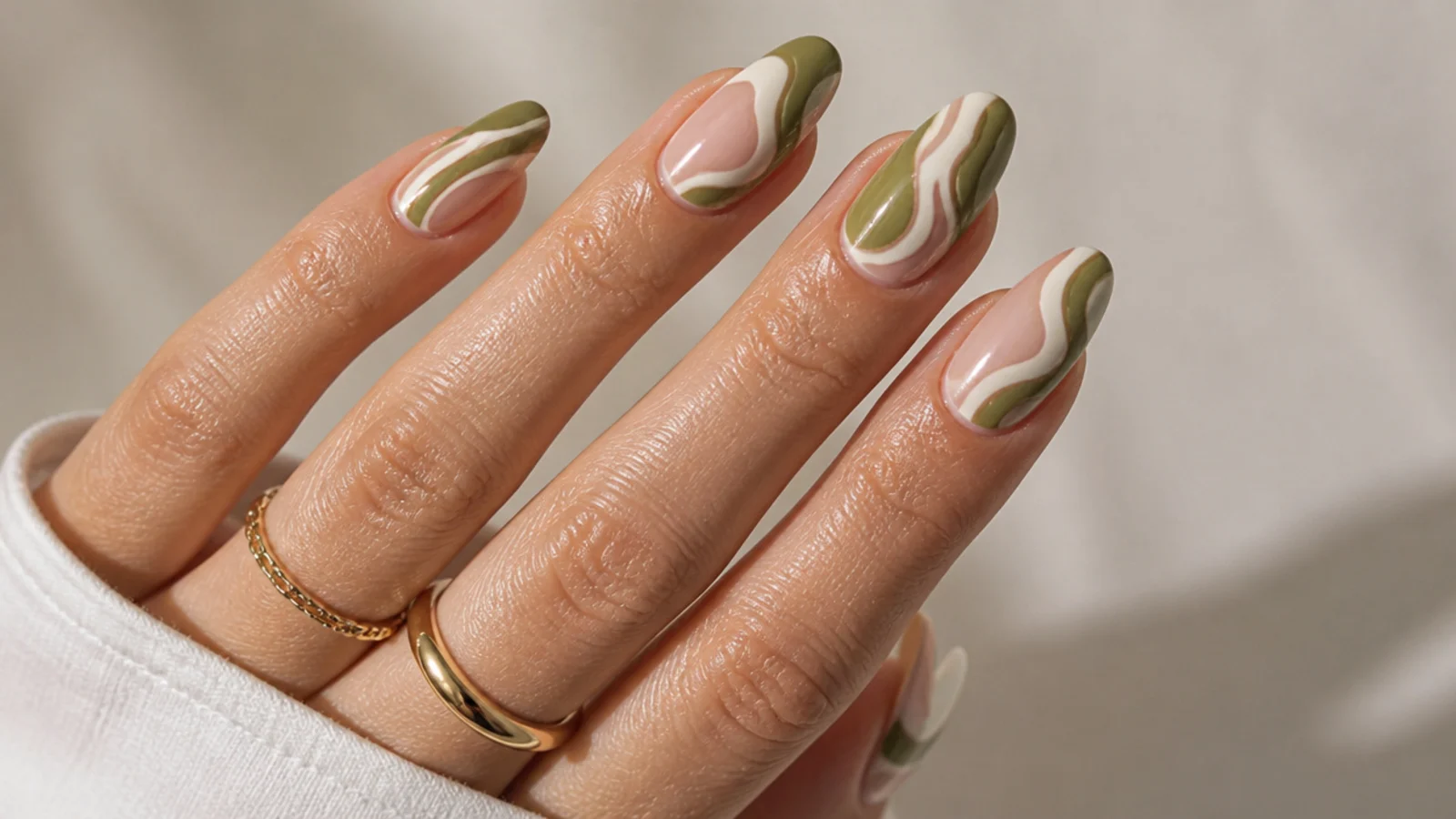 Olive green and cream swirl acrylic nails with a retro wave pattern